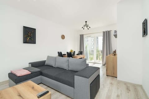 Bedroom with a corner sofa and dining ara.