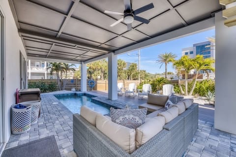 The pool area has a couch with room for everyone to hangout at.