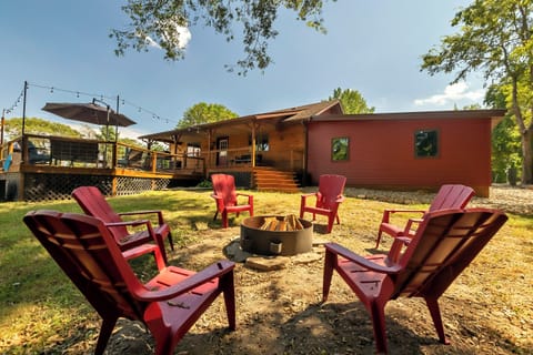 Back yard outdoor space with firepit, cornhole, pool and fishing pond