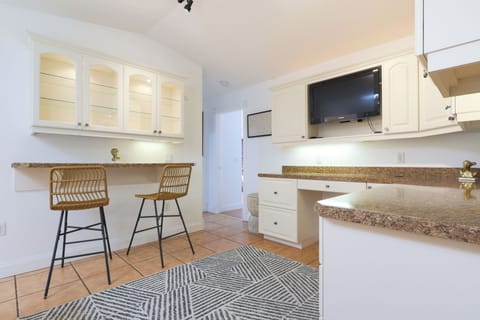 Kitchen area with ample counter space and two cozy bar seats