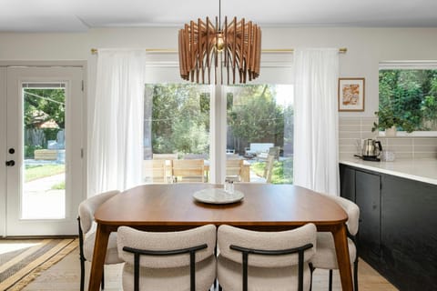 This mid-century dining room table comfortably seats 6, but has the option to extend with a leaf to accommodate 8, making it perfect for hosting intimate dinners or larger gatherings with friends and family. New chandelier photos coming soon! 