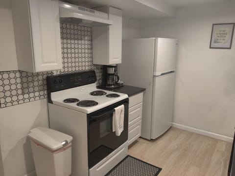 The small-sized kitchen has all new appliances. Refrigerator, microwave, dishwasher, stove, oven, toaster, and coffee maker. The kitchen is stocked with cooking basics such as pots, pans, bowls, plates, and cups.