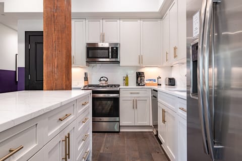 Cook or snack in style with a full kitchen featuring GE stainless appliances, cookware, and an island with bar seating. Ideal for short or extended stays, our kitchens make group travel in New Orleans easy and comfortable.