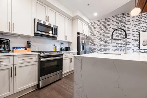 Cook or snack in style with a full kitchen featuring GE stainless appliances, cookware, and an island with bar seating. Ideal for short or extended stays, our kitchens make group travel in New Orleans easy and comfortable.