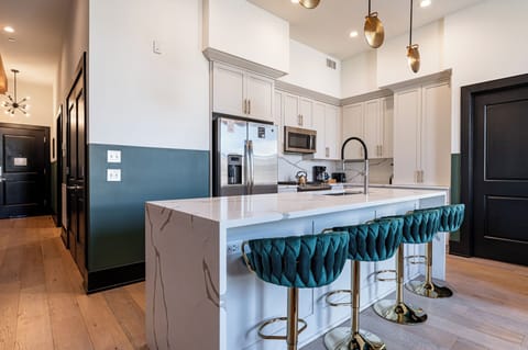 Cook or snack in style with a full kitchen featuring GE stainless appliances, cookware, and an island with bar seating. Ideal for short or extended stays, our kitchens make group travel in New Orleans easy and comfortable.