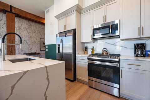 Cook or snack in style with a full kitchen featuring GE stainless appliances, cookware, and an island with bar seating. Ideal for short or extended stays, our kitchens make group travel in New Orleans easy and comfortable.