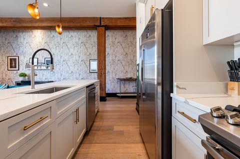 Cook or snack in style with a full kitchen featuring GE stainless appliances, cookware, and an island with bar seating. Ideal for short or extended stays, our kitchens make group travel in New Orleans easy and comfortable.