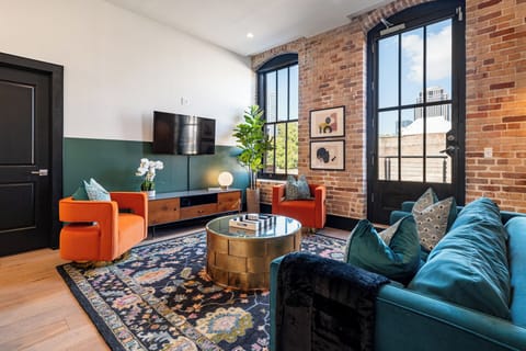 Relax in the living area with a smart TV, stylish seating, and a sleeper sofa for extra guests. Perfect for families or group stays in New Orleans, this inviting space is ideal for movie nights or recharging after a day in the city.
