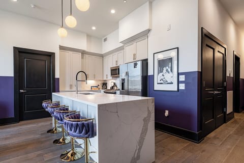 Cook or snack in style with a full kitchen featuring GE stainless appliances, cookware, and an island with bar seating. Ideal for short or extended stays, our kitchens make group travel in New Orleans easy and comfortable.