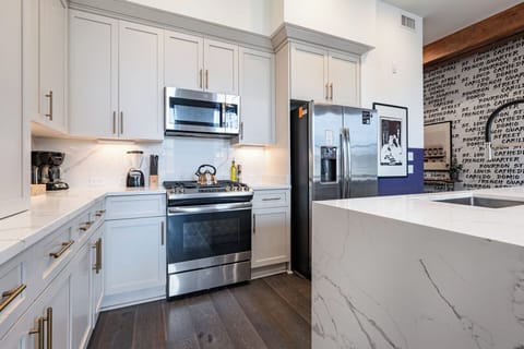 Cook or snack in style with a full kitchen featuring GE stainless appliances, cookware, and an island with bar seating. Ideal for short or extended stays, our kitchens make group travel in New Orleans easy and comfortable.