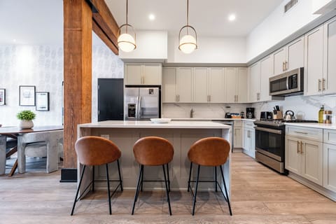 Cook or snack in style with a full kitchen featuring GE stainless appliances, cookware, and an island with bar seating. Ideal for short or extended stays, our kitchens make group travel in New Orleans easy and comfortable.