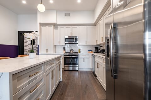 Cook or snack in style with a full kitchen featuring GE stainless appliances, cookware, and an island with bar seating. Ideal for short or extended stays, our kitchens make group travel in New Orleans easy and comfortable.