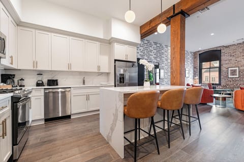 Cook or snack in style with a full kitchen featuring GE stainless appliances, cookware, and an island with bar seating. Ideal for short or extended stays, our kitchens make group travel in New Orleans easy and comfortable.