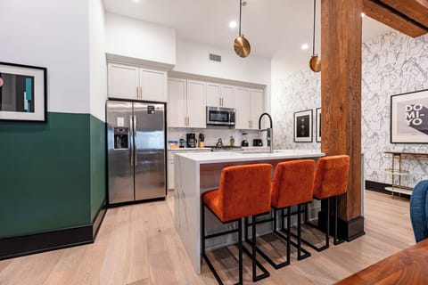 Cook or snack in style with a full kitchen featuring GE stainless appliances, cookware, and an island with bar seating. Ideal for short or extended stays, our kitchens make group travel in New Orleans easy and comfortable.