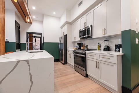 Cook or snack in style with a full kitchen featuring GE stainless appliances, cookware, and an island with bar seating. Ideal for short or extended stays, our kitchens make group travel in New Orleans easy and comfortable.