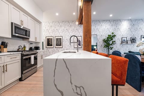 Cook or snack in style with a full kitchen featuring GE stainless appliances, cookware, and an island with bar seating. Ideal for short or extended stays, our kitchens make group travel in New Orleans easy and comfortable.