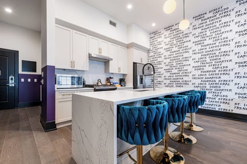 Cook or snack in style with a full kitchen featuring GE stainless appliances, cookware, and an island with bar seating. Ideal for short or extended stays, our kitchens make group travel in New Orleans easy and comfortable.