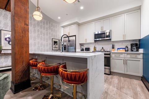 Cook or snack in style with a full kitchen featuring GE stainless appliances, cookware, and an island with bar seating. Ideal for short or extended stays, our kitchens make group travel in New Orleans easy and comfortable.