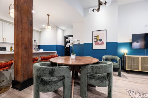 Enjoy meals together at your in-suite dining table with seating for your group. Whether it's takeout, delivery, or a home-cooked meal, this cozy dining area makes every stay at 888 Baronne feel like home in New Orleans.