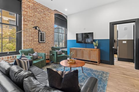 Relax in the living area with a smart TV, stylish seating, and a sleeper sofa for extra guests. Perfect for families or group stays in New Orleans, this inviting space is ideal for movie nights or recharging after a day in the city.