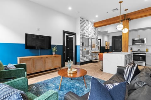 Relax in the living area with a smart TV, stylish seating, and a sleeper sofa for extra guests. Perfect for families or group stays in New Orleans, this inviting space is ideal for movie nights or recharging after a day in the city.