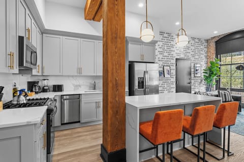 Cook or snack in style with a full kitchen featuring GE stainless appliances, cookware, and an island with bar seating. Ideal for short or extended stays, our kitchens make group travel in New Orleans easy and comfortable.