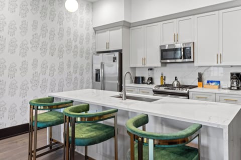 Cook or snack in style with a full kitchen featuring GE stainless appliances, cookware, and an island with bar seating. Ideal for short or extended stays, our kitchens make group travel in New Orleans easy and comfortable.