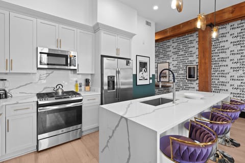 Cook or snack in style with a full kitchen featuring GE stainless appliances, cookware, and an island with bar seating. Ideal for short or extended stays, our kitchens make group travel in New Orleans easy and comfortable.