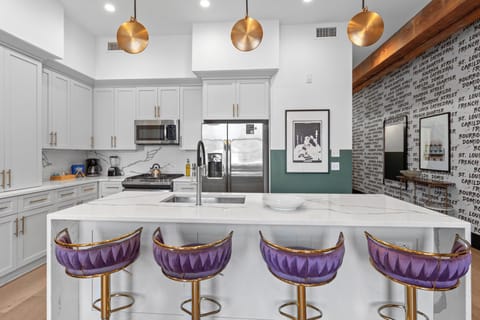 Cook or snack in style with a full kitchen featuring GE stainless appliances, cookware, and an island with bar seating. Ideal for short or extended stays, our kitchens make group travel in New Orleans easy and comfortable.