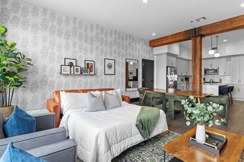 Relax in the living area with a smart TV, stylish seating, and a sleeper sofa for extra guests. Perfect for families or group stays in New Orleans, this inviting space is ideal for movie nights or recharging after a day in the city.