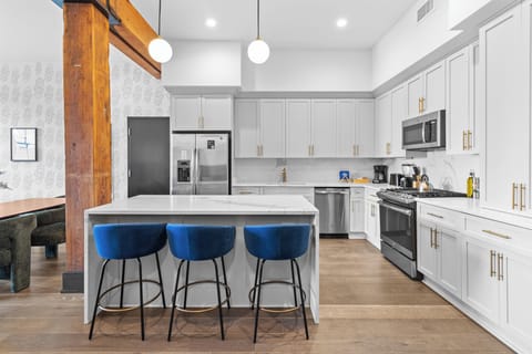 Cook or snack in style with a full kitchen featuring GE stainless appliances, cookware, and an island with bar seating. Ideal for short or extended stays, our kitchens make group travel in New Orleans easy and comfortable.