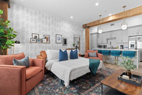 Relax in the living area with a smart TV, stylish seating, and a sleeper sofa for extra guests. Perfect for families or group stays in New Orleans, this inviting space is ideal for movie nights or recharging after a day in the city.