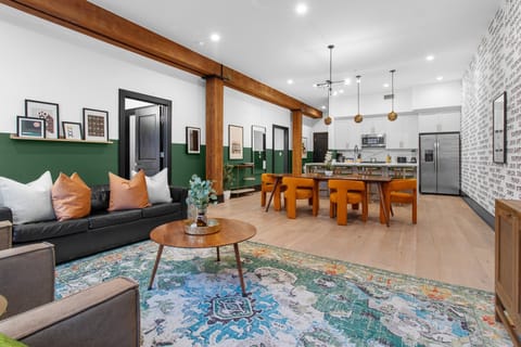 Relax in the living area with a smart TV, stylish seating, and a sleeper sofa for extra guests. Perfect for families or group stays in New Orleans, this inviting space is ideal for movie nights or recharging after a day in the city.