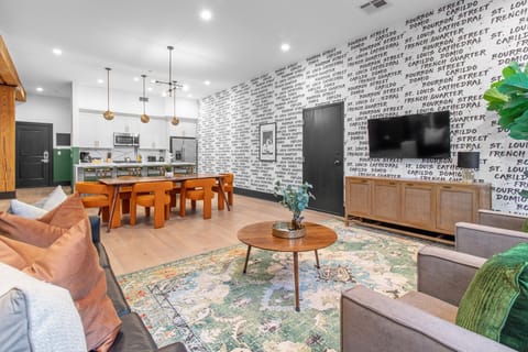 Relax in the living area with a smart TV, stylish seating, and a sleeper sofa for extra guests. Perfect for families or group stays in New Orleans, this inviting space is ideal for movie nights or recharging after a day in the city.