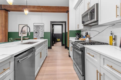 Cook or snack in style with a full kitchen featuring GE stainless appliances, cookware, and an island with bar seating. Ideal for short or extended stays, our kitchens make group travel in New Orleans easy and comfortable.