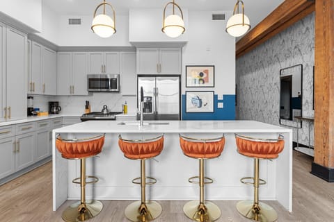 Cook or snack in style with a full kitchen featuring GE stainless appliances, cookware, and an island with bar seating. Ideal for short or extended stays, our kitchens make group travel in New Orleans easy and comfortable.