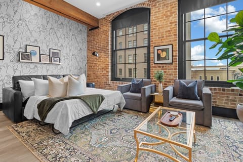 Relax in the living area with a smart TV, stylish seating, and a sleeper sofa for extra guests. Perfect for families or group stays in New Orleans, this inviting space is ideal for movie nights or recharging after a day in the city.