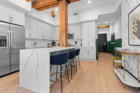 Cook or snack in style with a full kitchen featuring GE stainless appliances, cookware, and an island with bar seating. Ideal for short or extended stays, our kitchens make group travel in New Orleans easy and comfortable.