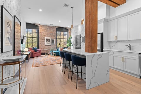 Cook or snack in style with a full kitchen featuring GE stainless appliances, cookware, and an island with bar seating. Ideal for short or extended stays, our kitchens make group travel in New Orleans easy and comfortable.