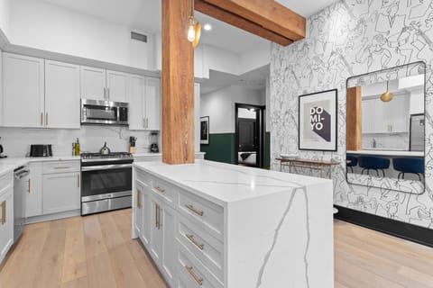 Cook or snack in style with a full kitchen featuring GE stainless appliances, cookware, and an island with bar seating. Ideal for short or extended stays, our kitchens make group travel in New Orleans easy and comfortable.