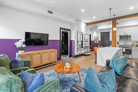 Relax in the living area with a smart TV, stylish seating, and a sleeper sofa for extra guests. Perfect for families or group stays in New Orleans, this inviting space is ideal for movie nights or recharging after a day in the city.