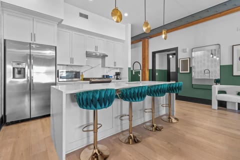 Cook or snack in style with a full kitchen featuring GE stainless appliances, cookware, and an island with bar seating. Ideal for short or extended stays, our kitchens make group travel in New Orleans easy and comfortable.