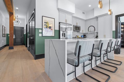 Cook or snack in style with a full kitchen featuring GE stainless appliances, cookware, and an island with bar seating. Ideal for short or extended stays, our kitchens make group travel in New Orleans easy and comfortable.