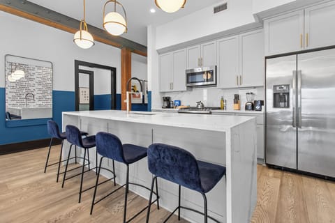 Cook or snack in style with a full kitchen featuring GE stainless appliances, cookware, and an island with bar seating. Ideal for short or extended stays, our kitchens make group travel in New Orleans easy and comfortable.