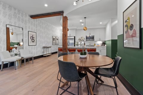 Enjoy meals together at your in-suite dining table with seating for your group. Whether it's takeout, delivery, or a home-cooked meal, this cozy dining area makes every stay at 888 Baronne feel like home in New Orleans.