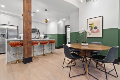 Enjoy meals together at your in-suite dining table with seating for your group. Whether it's takeout, delivery, or a home-cooked meal, this cozy dining area makes every stay at 888 Baronne feel like home in New Orleans.