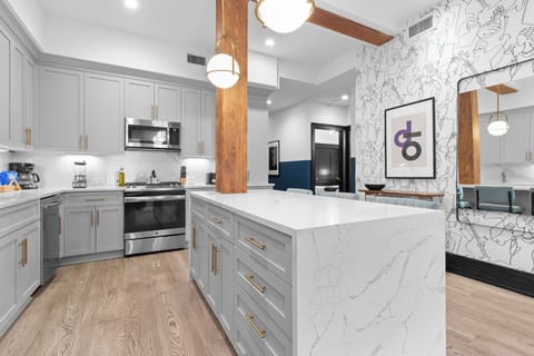 Cook or snack in style with a full kitchen featuring GE stainless appliances, cookware, and an island with bar seating. Ideal for short or extended stays, our kitchens make group travel in New Orleans easy and comfortable.