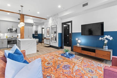 Relax in the living area with a smart TV, stylish seating, and a sleeper sofa for extra guests. Perfect for families or group stays in New Orleans, this inviting space is ideal for movie nights or recharging after a day in the city.