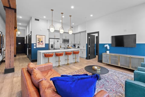 Relax in the living area with a smart TV, stylish seating, and a sleeper sofa for extra guests. Perfect for families or group stays in New Orleans, this inviting space is ideal for movie nights or recharging after a day in the city.