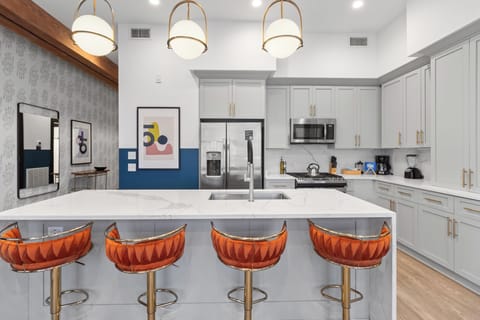 Cook or snack in style with a full kitchen featuring GE stainless appliances, cookware, and an island with bar seating. Ideal for short or extended stays, our kitchens make group travel in New Orleans easy and comfortable.